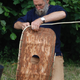 An experimental archaeologist reconstructing the bark shield.